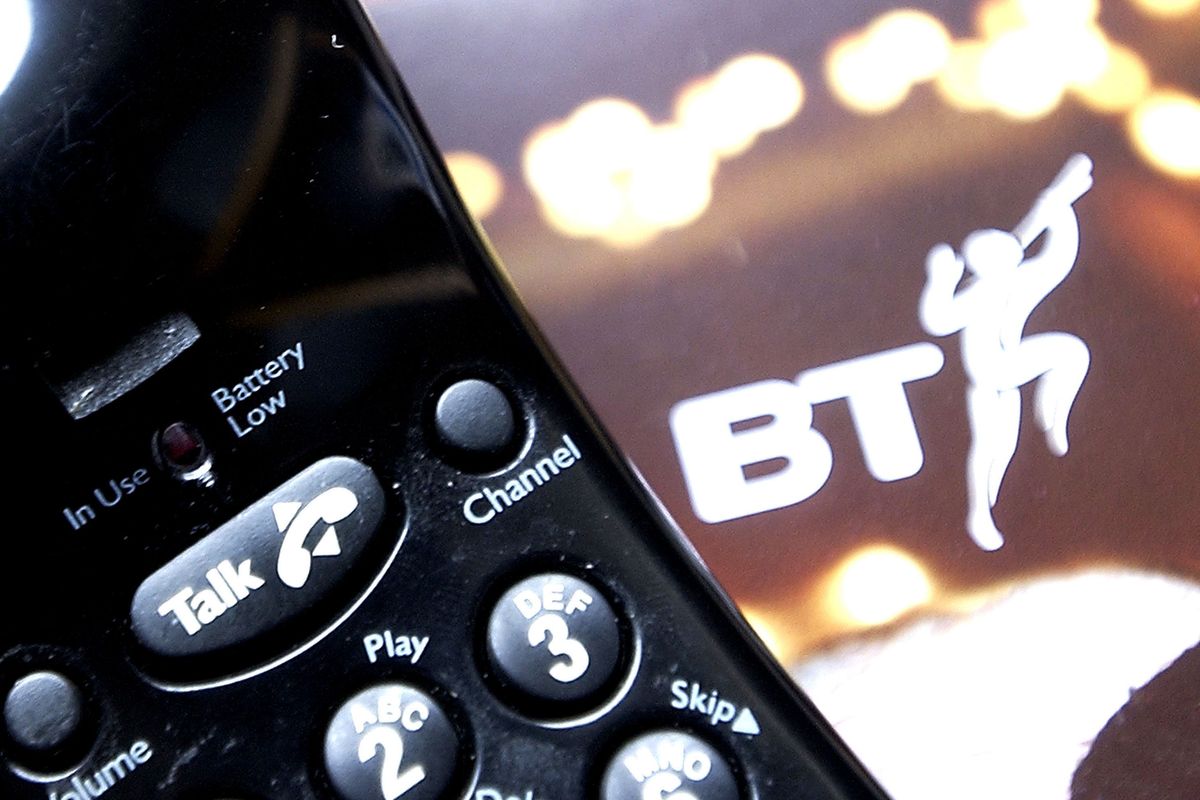 a traditional home phone for use with copper line landlines pictured with the previous BT logo in the background