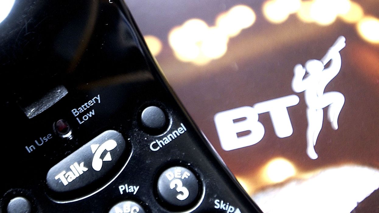 a traditional home phone for use with copper line landlines pictured with the previous BT logo in the background