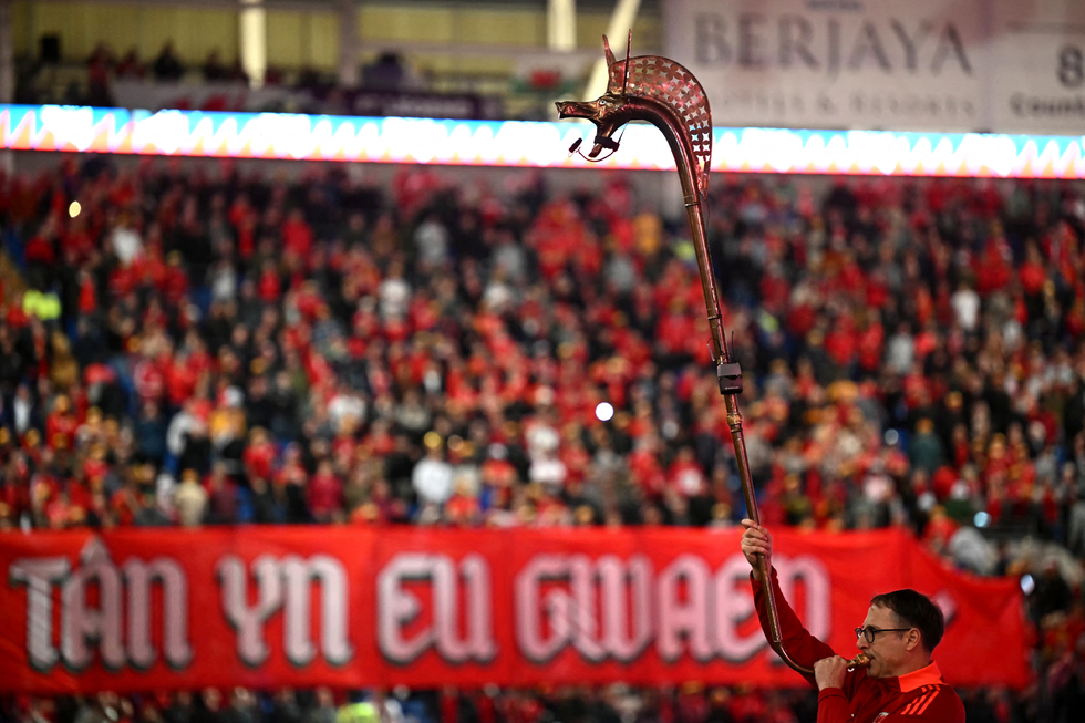 A trumpeter blasts a newly-built carnyx ahead of a Wales vs Belgium World Cup qualifying match