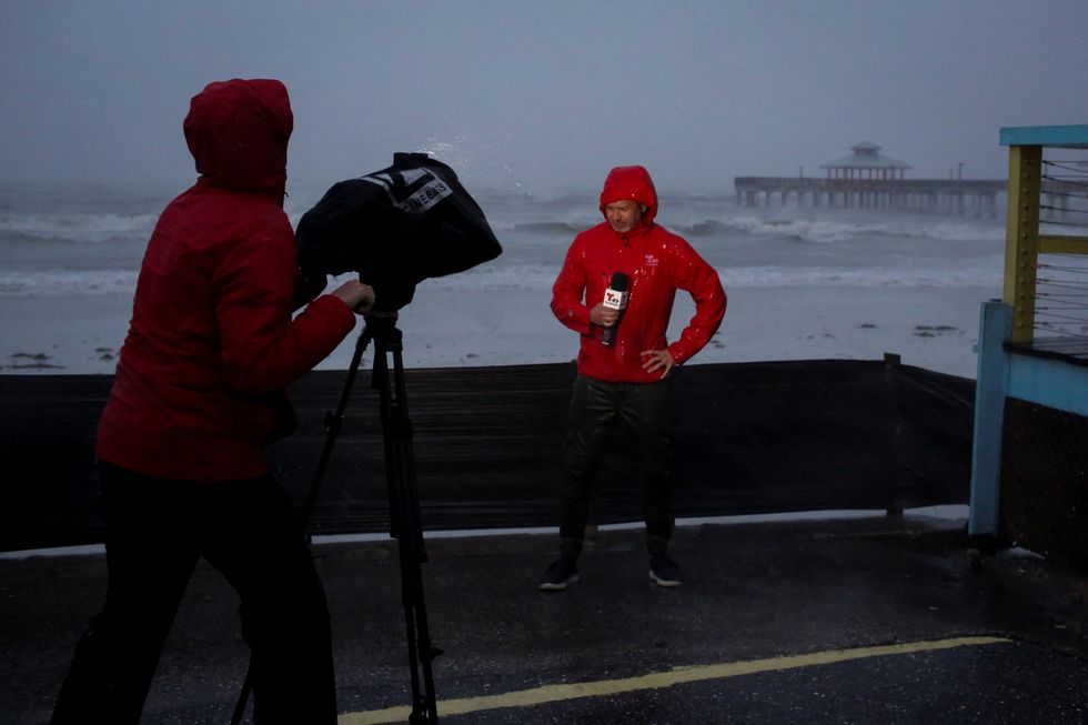 A TV crew broadcast from the beach at Fort Myers ahead of Hurricane Ian, in Fort Myers, Florida, U.S.