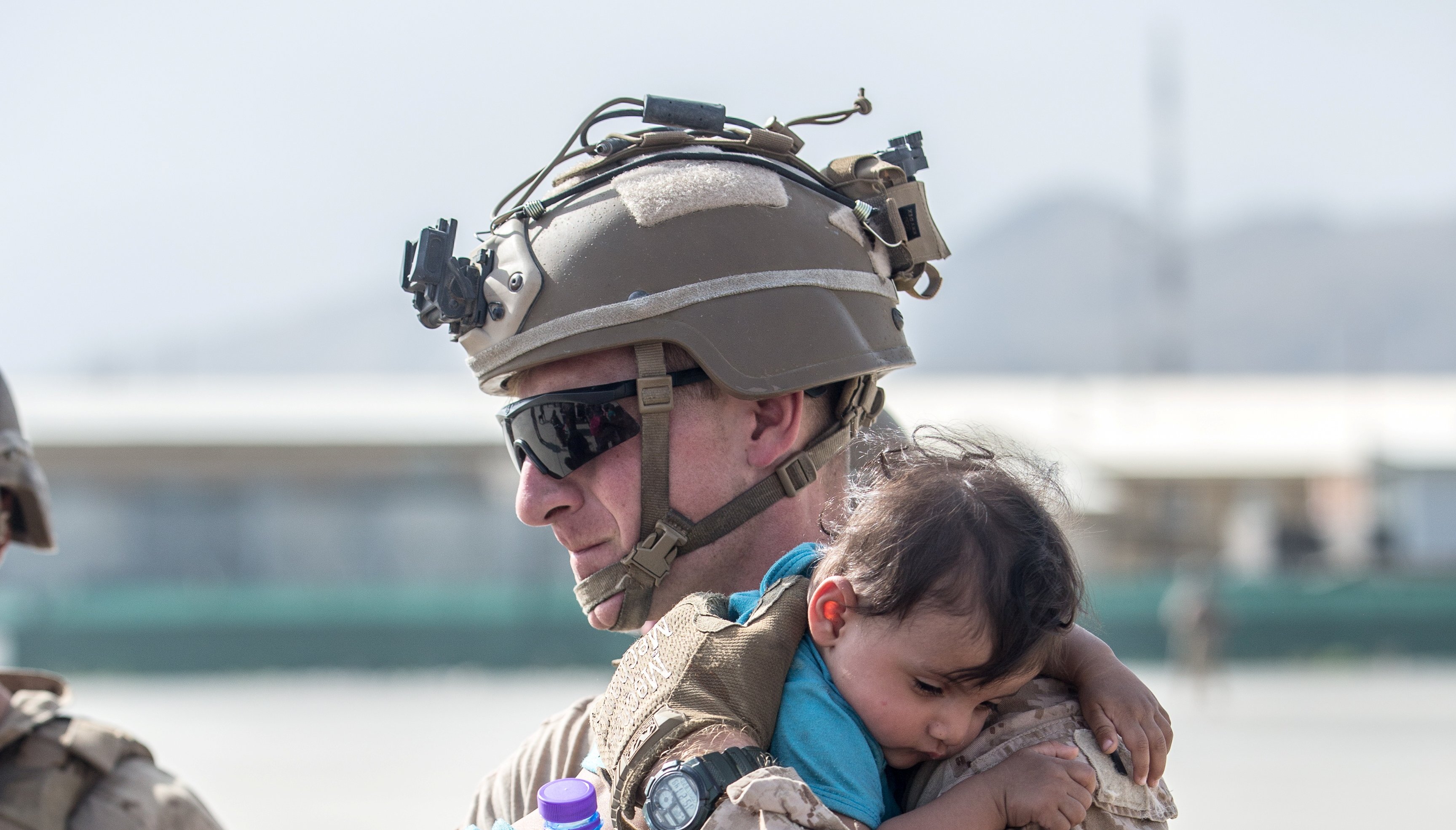 A U.S. Marine calms an infant during an evacuation at Hamid Karzai International Airport, Kabul.