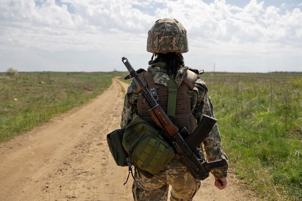 A Ukrainian servicewoman walks at a position, as Russia's attack on Ukraine continues, in Luhansk Region, Ukraine.