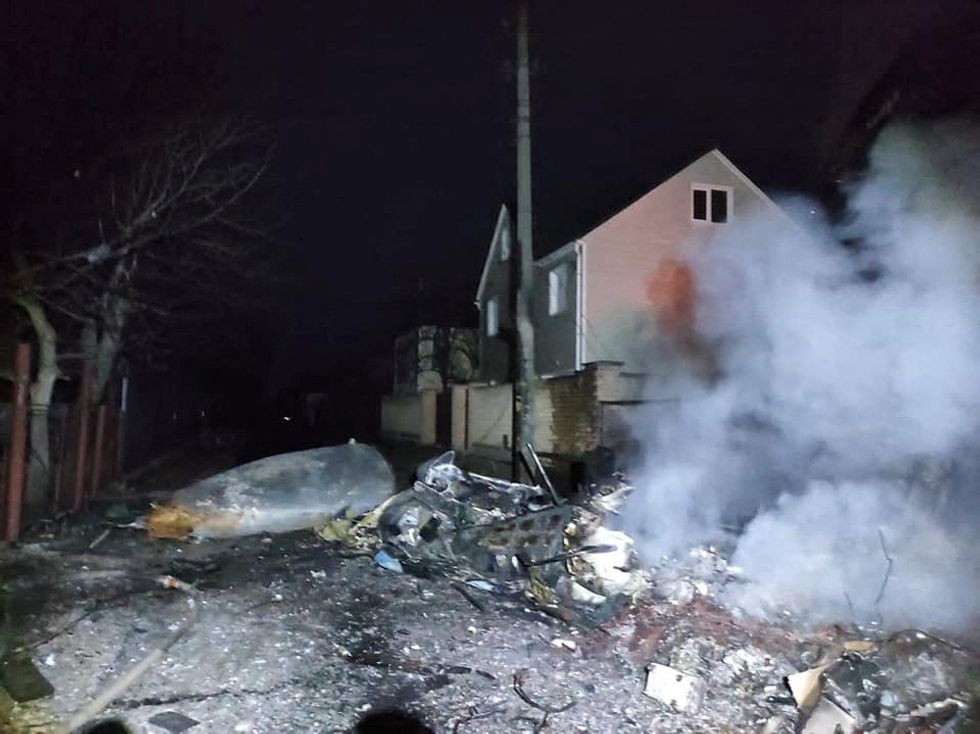 A view shows the wreckage of an unidentified aircraft in a residential area in Kyiv, Ukraine, in this handout picture released February 25, 2022. Press service of the Ukrainian State Emergency Service/Handout via REUTERS.