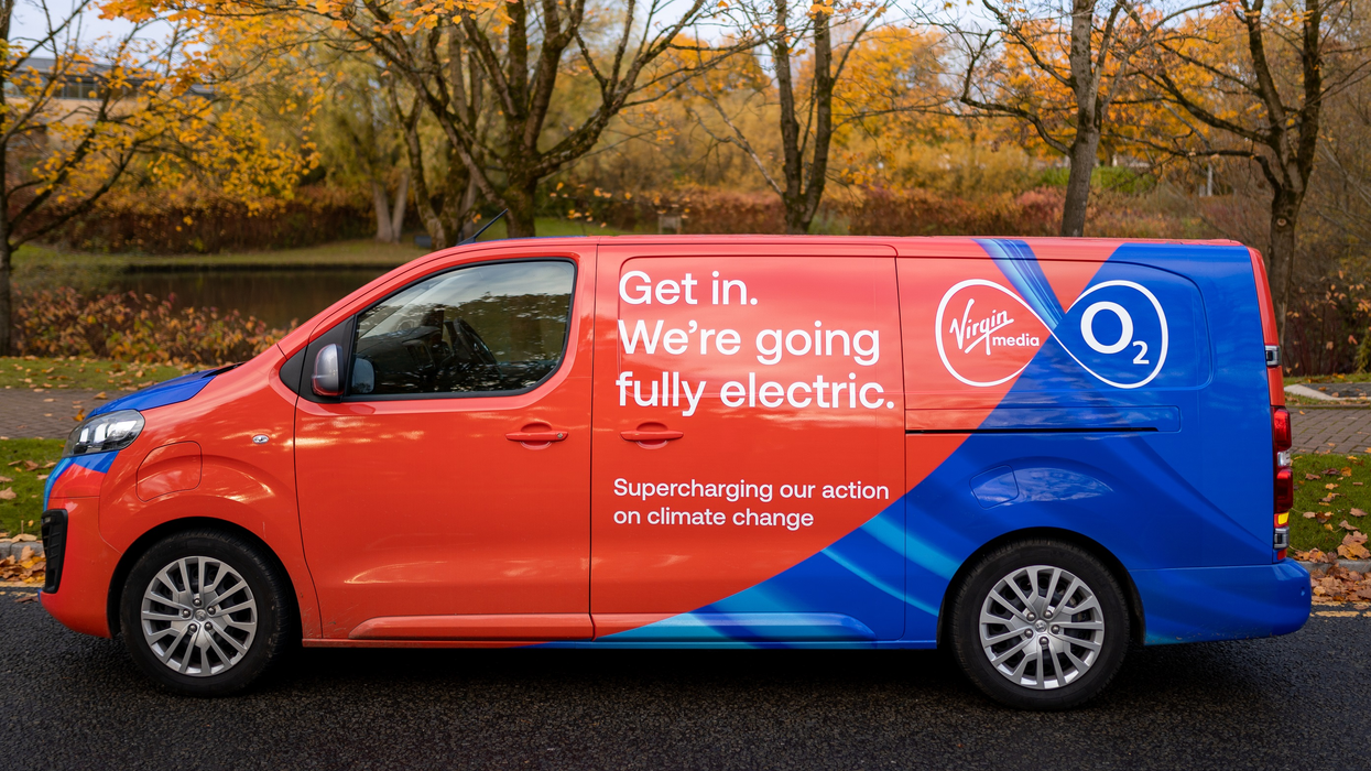 a virgin media o2 van is pictured parked on the side of the street in autumn
