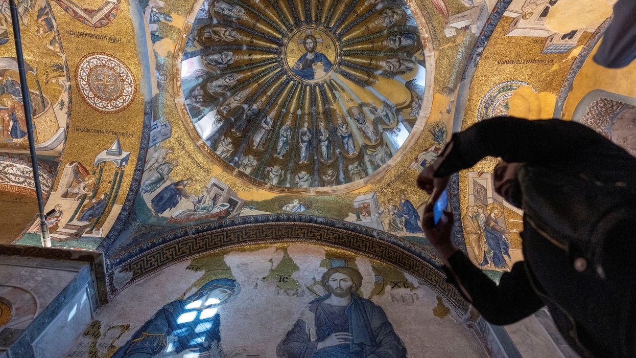 A visitor takes a picture at Chora Museum or Kariye Mosque