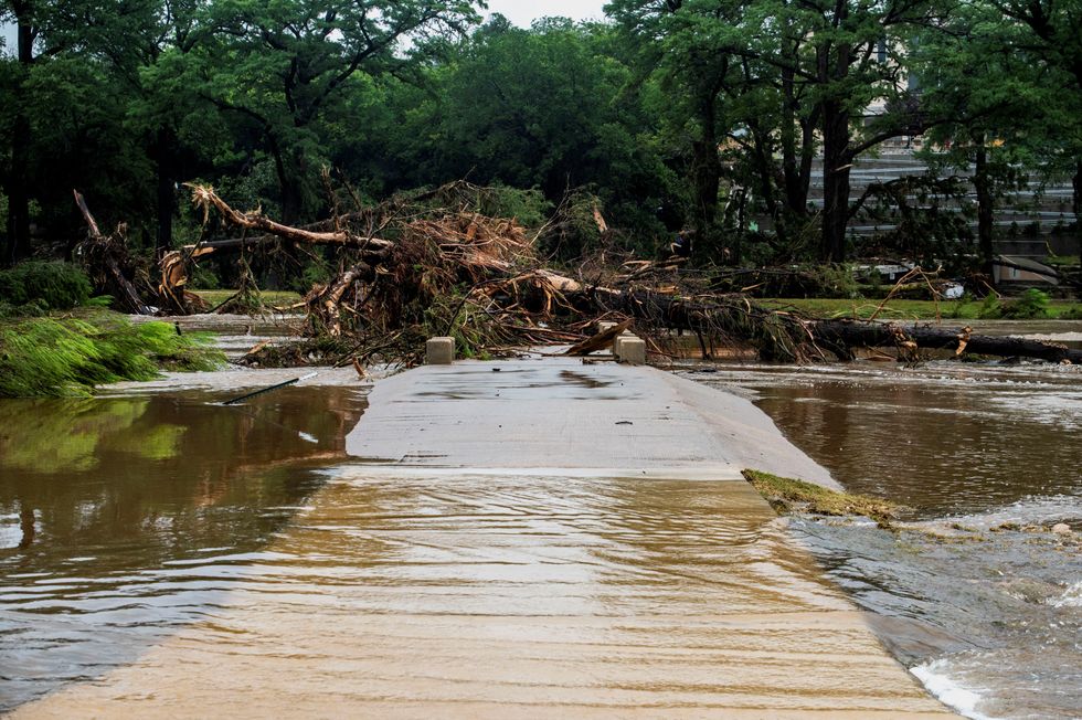A walkway is blocked by fallen trees following deadly flooding in Kerrville, Texas