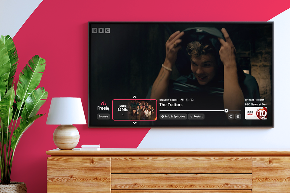 a wall-mounted television with the freely user interface on-screen watching The Traitors on BBC One