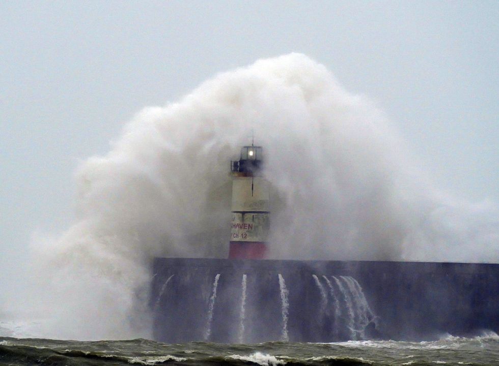 A wave crashes over Newhaven lighthouse at West Quay in East Sussex, following on from Storm Eunice last week.
