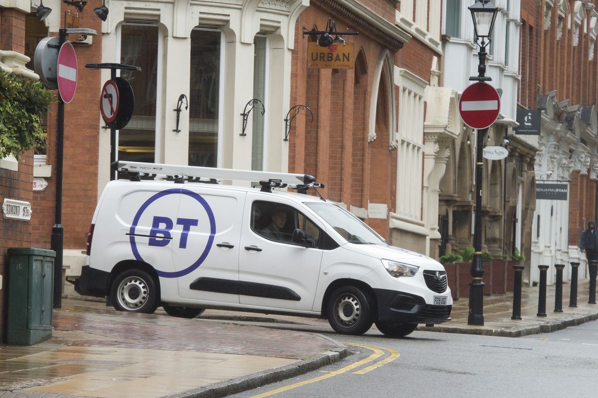 a white van branded with the bt logo drives around a street in Birmingham