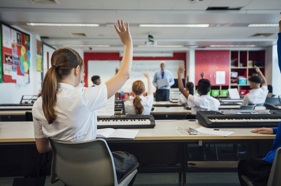 A wide-view shot of teenage music students in a classroom