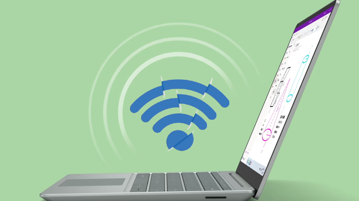 a windows 11 laptop is pictured on a green background with a broken wifi symbol