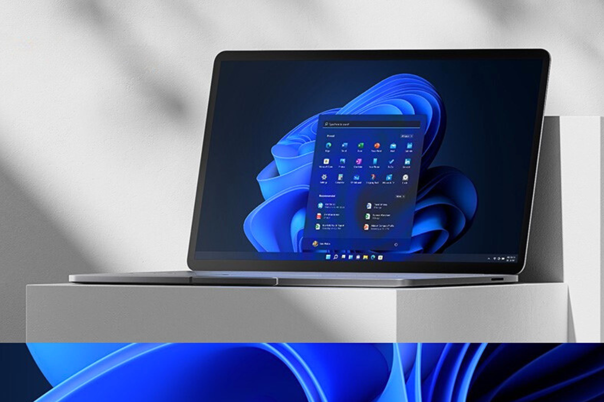 a windows 11 laptop with the start menu open sits on a pedestal