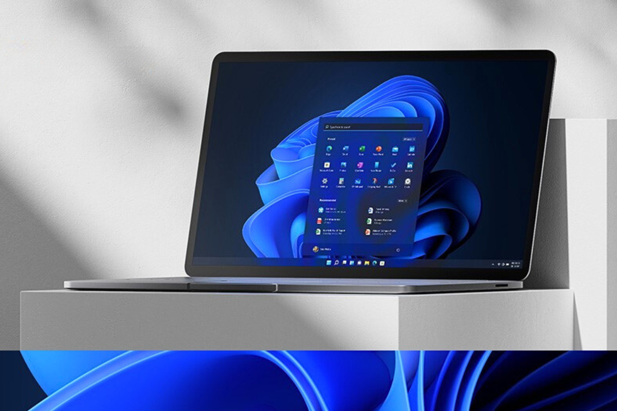 a windows 11 laptop with the start menu open sits on a pedestal