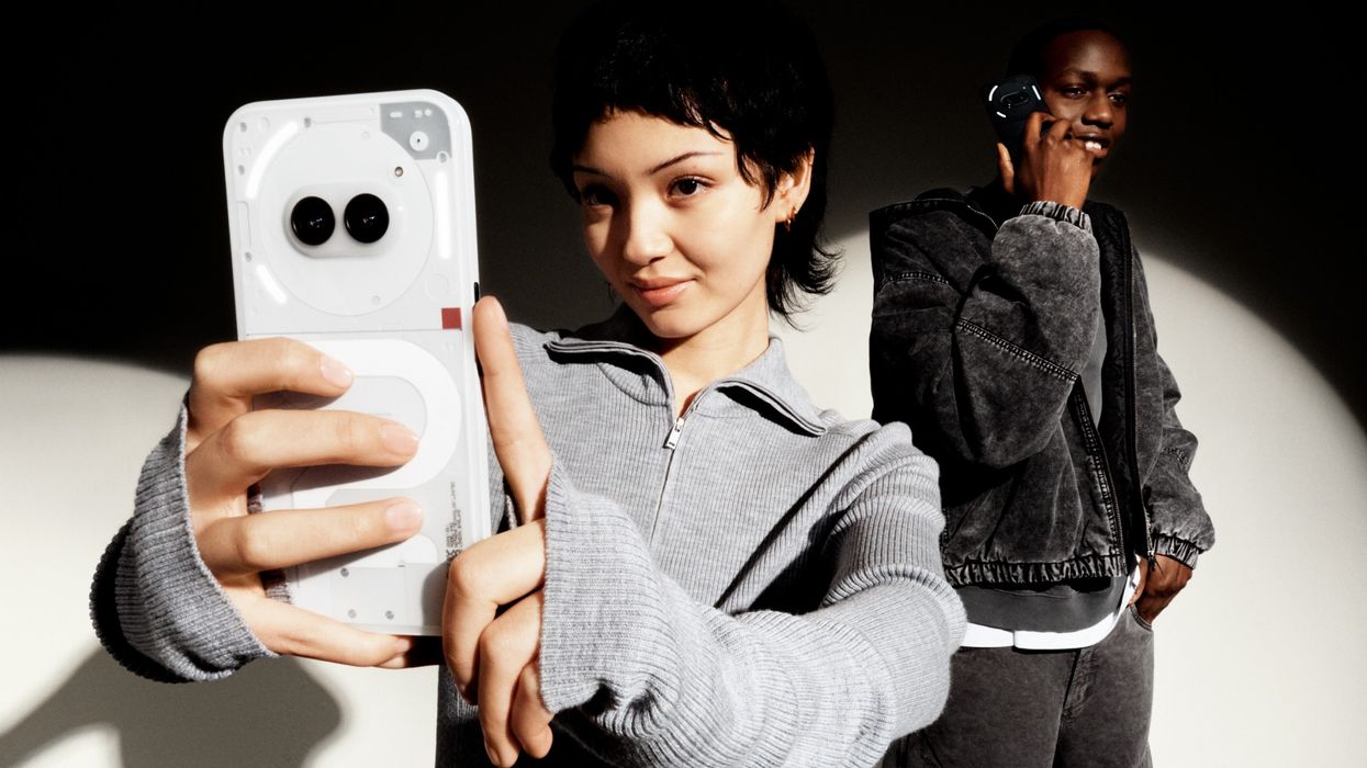 a woman and man wearing a grey sweatshirts holding nothing phone 2a in white and black colourways