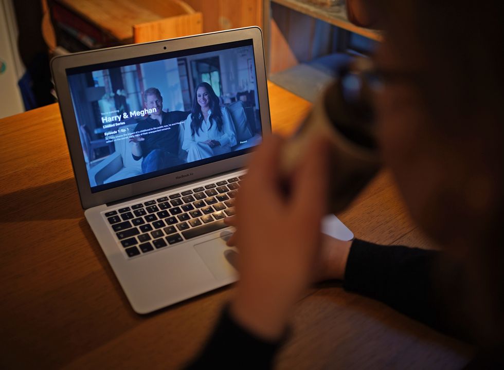 A woman at home in London watching the Duke and Duchess of Sussex's controversial documentary being aired on Netflix. Harry & Meghan - a six-part docuseries - dropped on the streaming giant at 8am in the UK on Thursday, with the royal family steeling themselves for the revelations in the first three episodes. Picture date: Thursday December 8, 2022.