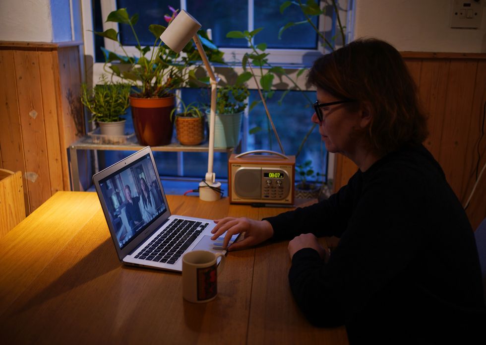 A woman at home in London watching the Duke and Duchess of Sussex's controversial documentary being aired on Netflix. Harry & Meghan - a six-part docuseries - dropped on the streaming giant at 8am in the UK on Thursday, with the royal family steeling themselves for the revelations in the first three episodes. Picture date: Thursday December 8, 2022.