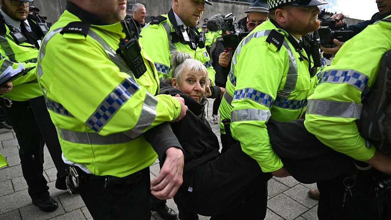 A woman being arrested by police during a Palestine Action protest on Sunday