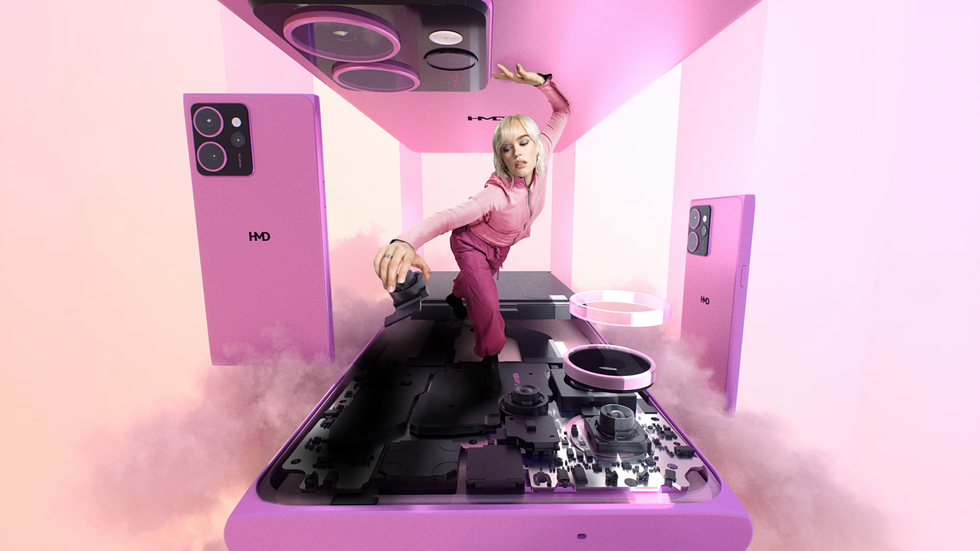 a woman climbs through a supersized hmd skyline phone and replaces a component