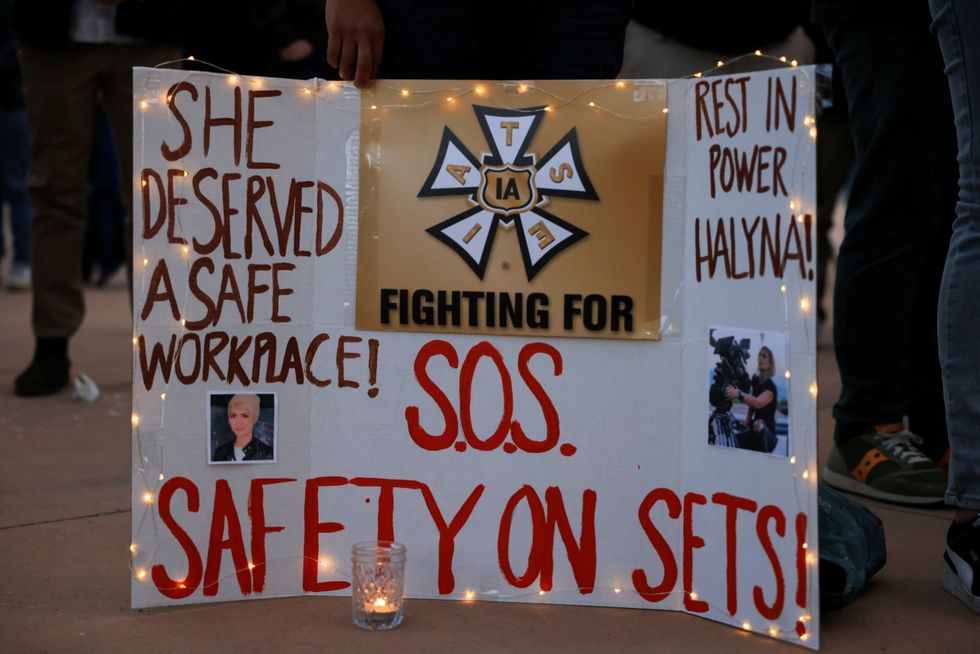 A woman displays a sign calling for workplace safety at a vigil for cinematographer Halyna Hutchins, who died after being shot by Alec Baldwin on the set of his movie \%22Rust\%22, in Albuquerque, New Mexico.