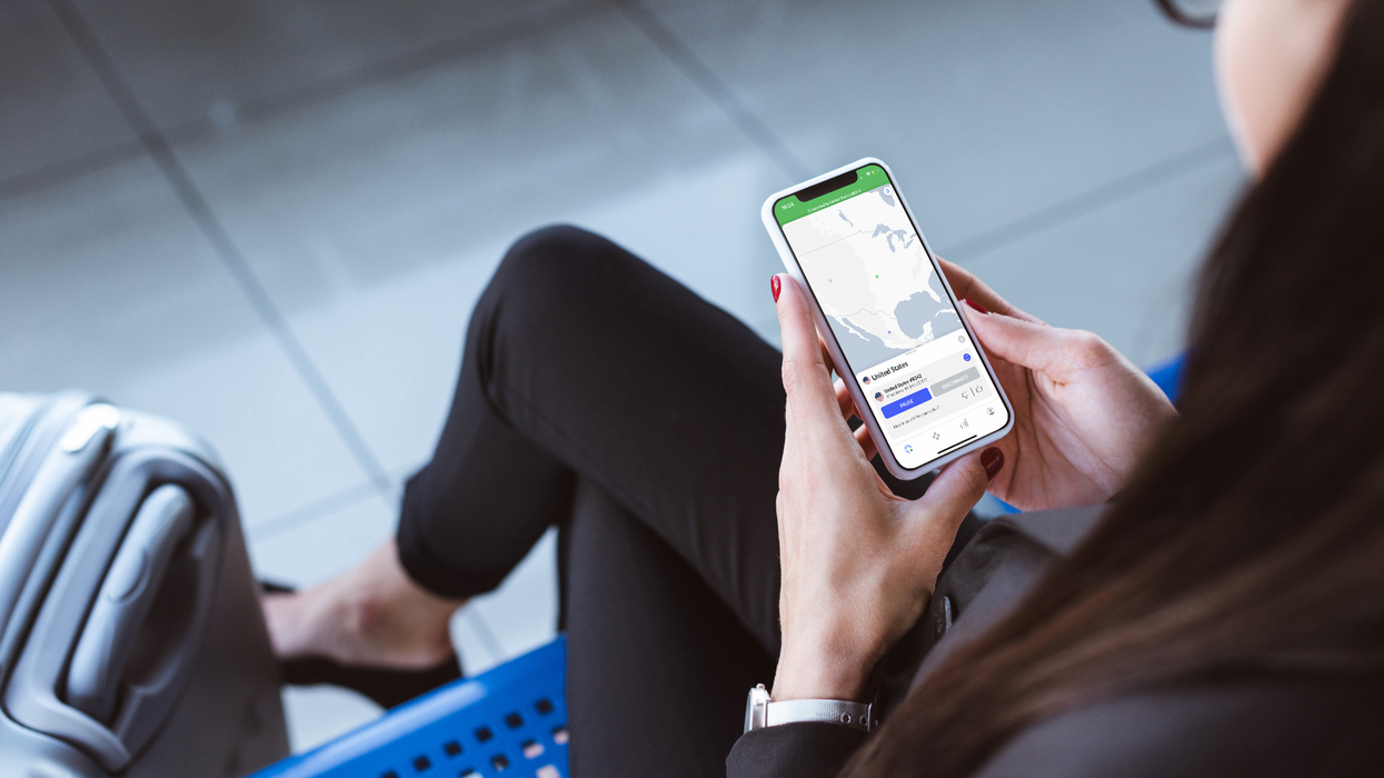 a woman enabling a VPN from her smartphone on a bench