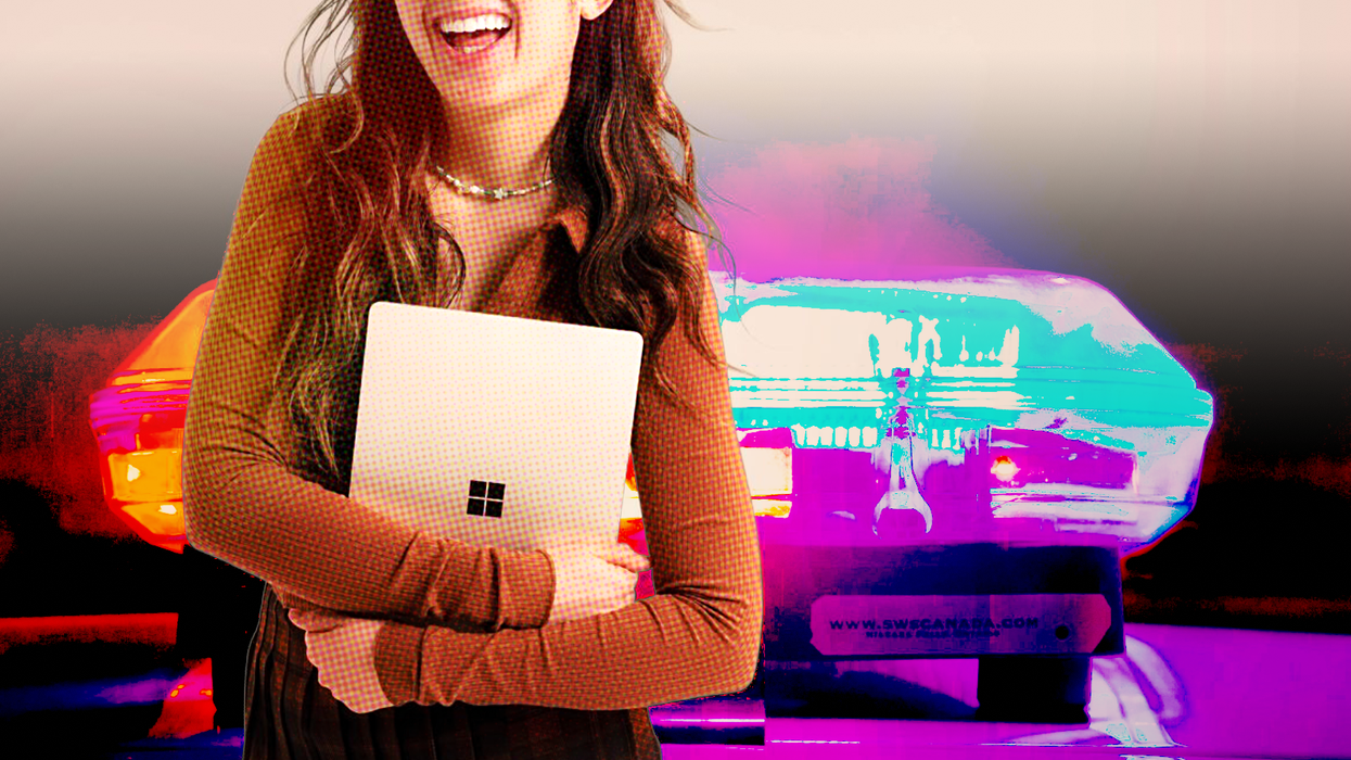 a woman holds a surface laptop with the microsoft logo with police sirens in the background