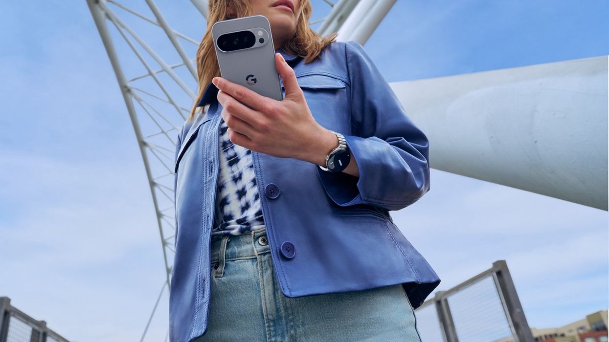 a woman in a blue overshirt holds the new pixel 10 Pro
