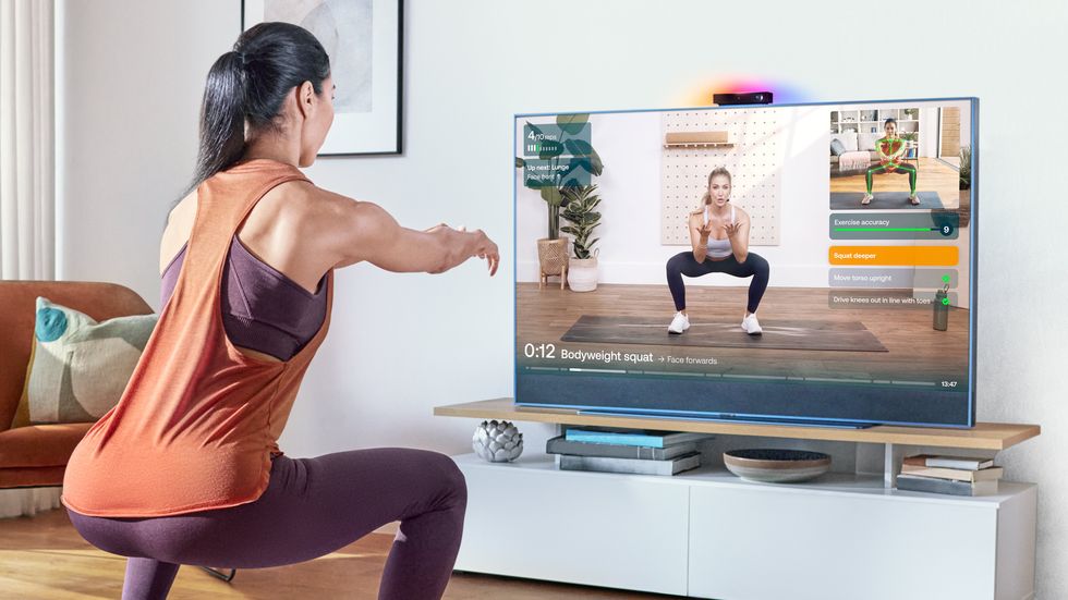 a woman in fitness gear uses Sky Live to workout