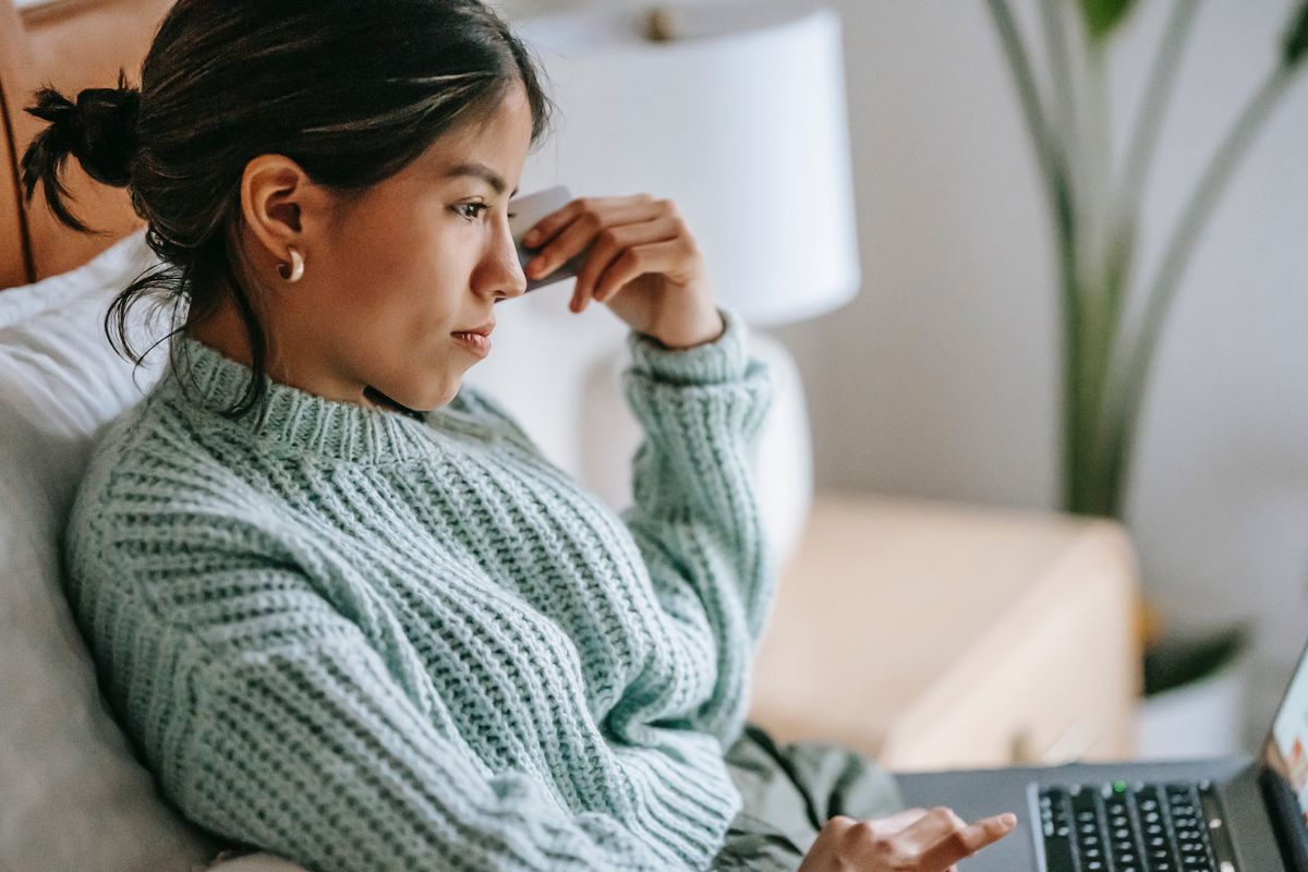 A woman looking on her laptop