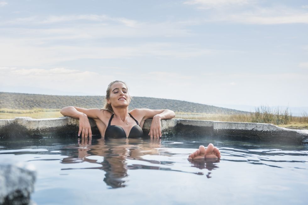 A woman lying in a hot tub