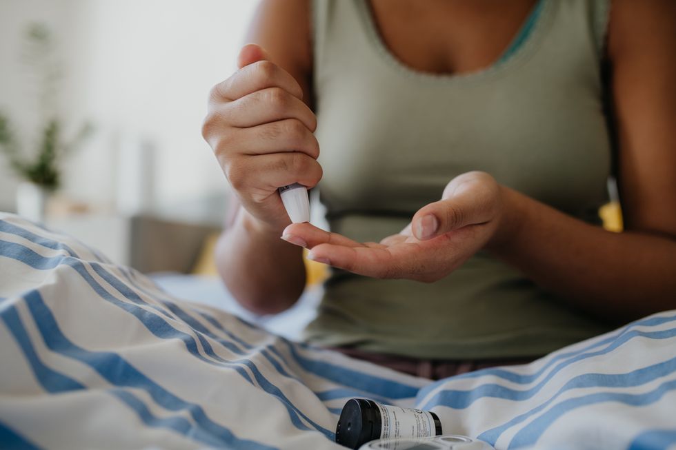 A woman measuring her blood sugar