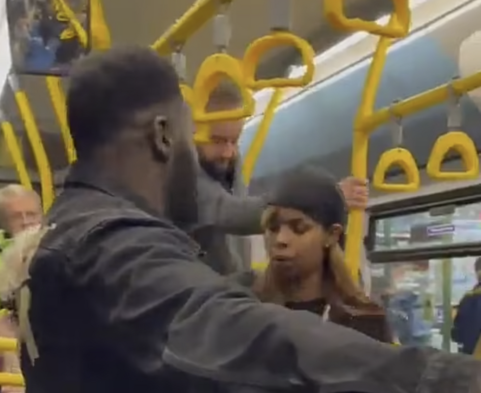 A woman on a bus wearing a bandana