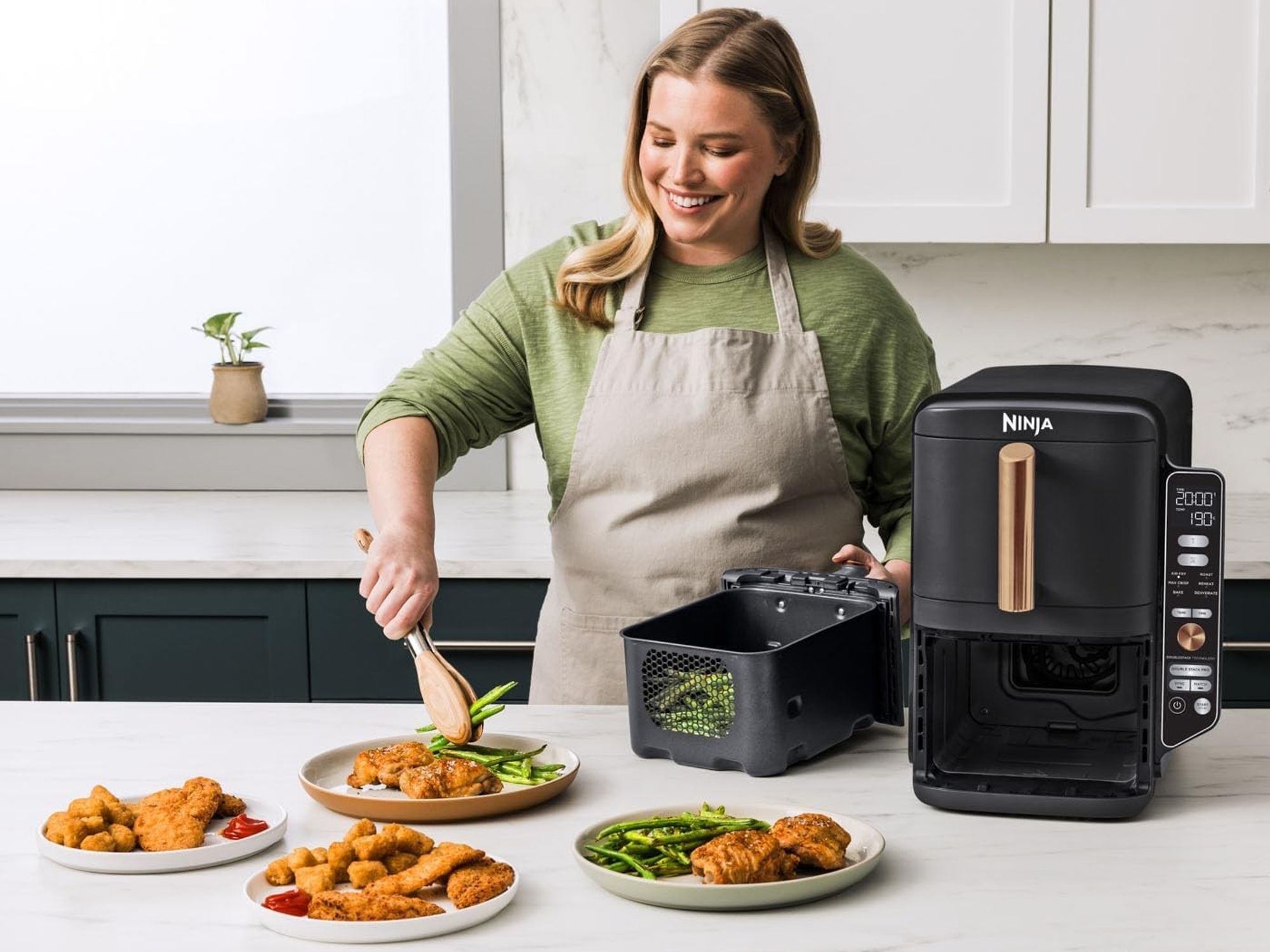a woman plates up dinner cooked in the ninja Double Stack XL Air Fryer