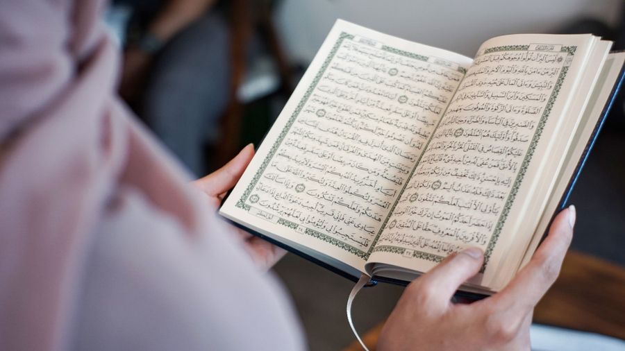 A woman reading the Koran