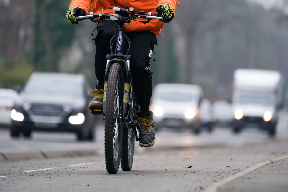 A woman rides along a cycle lane next to heavy traffic in Birmingham. The Highway Code is due to be updated on January 29, pending parliamentary approval, to introduce a risk-based hierarchy of road users. Someone driving will have more responsibility to watch out for people cycling, walking or riding a horse, and cyclists will have more responsibility to be aware of pedestrians. Picture date: Tuesday January 25, 2022.