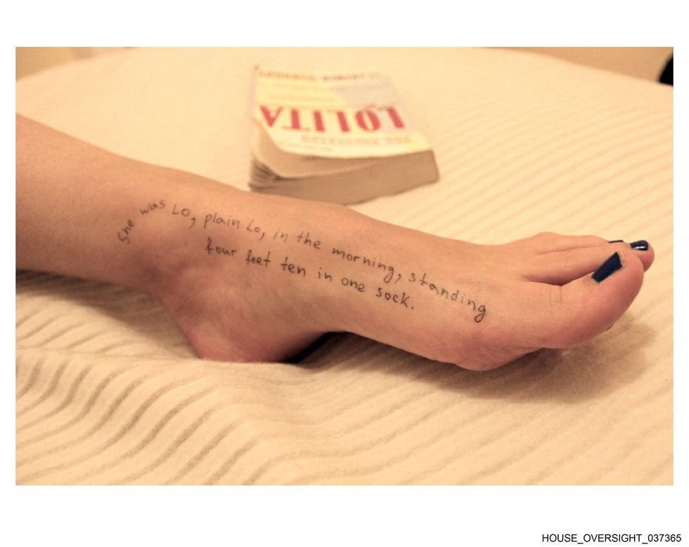 A woman's foot with writing on it