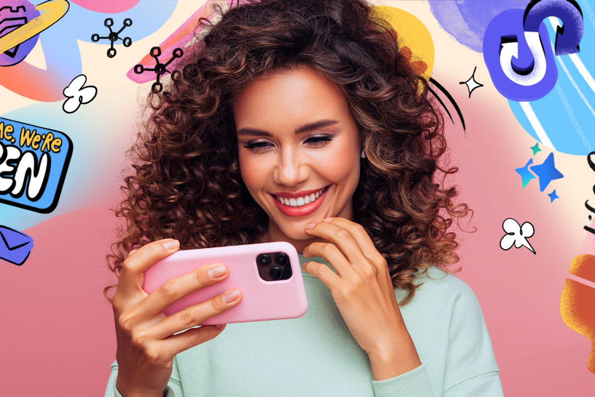 a woman smiles looking at an iPhone with colourful graphics from Samsung behind her advertising its Try Galaxy service 