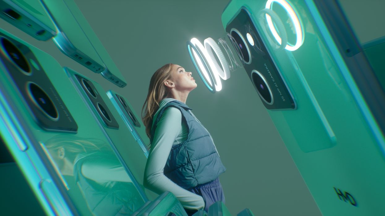 a woman stares into the camera module of an android smartphone