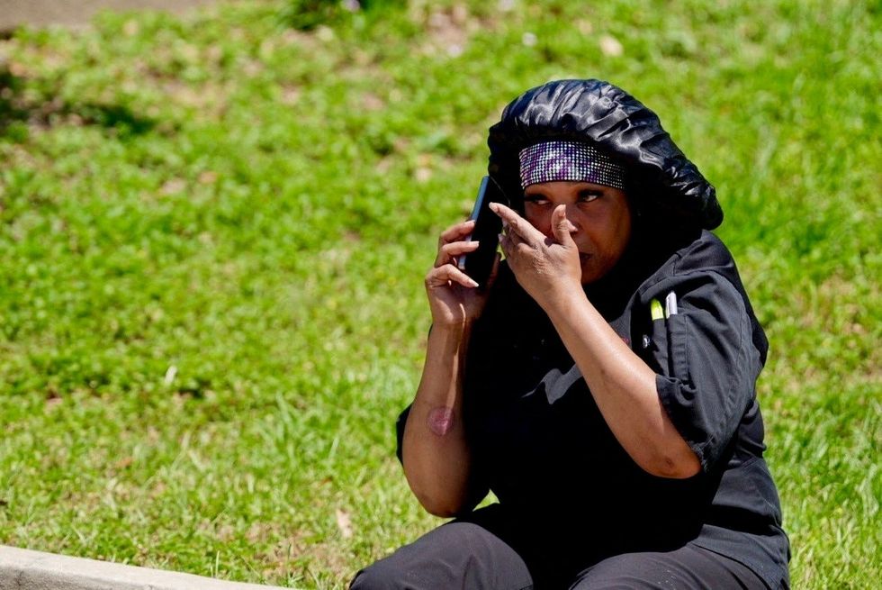 A woman talks on her phone after being evacuated from Florida State University (FSU) campus