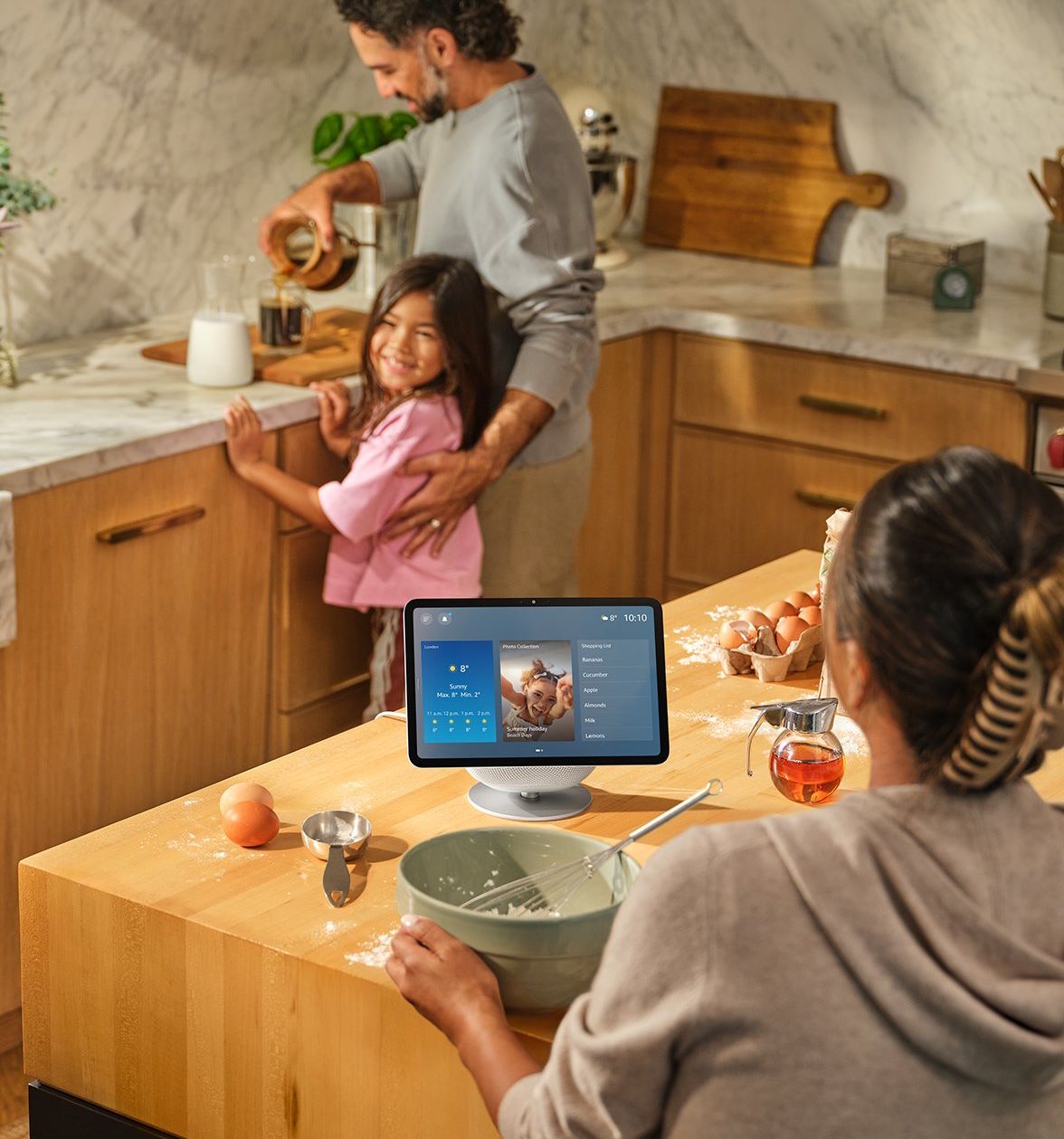 a woman uses the adjustable stand for the echo show at the kitchen countertop