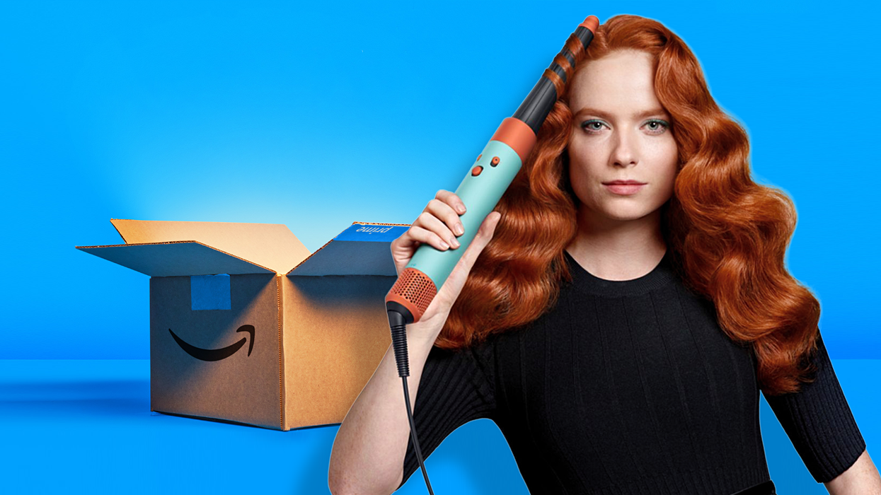 a woman uses the dyson airwrap i.d. to style her hair
