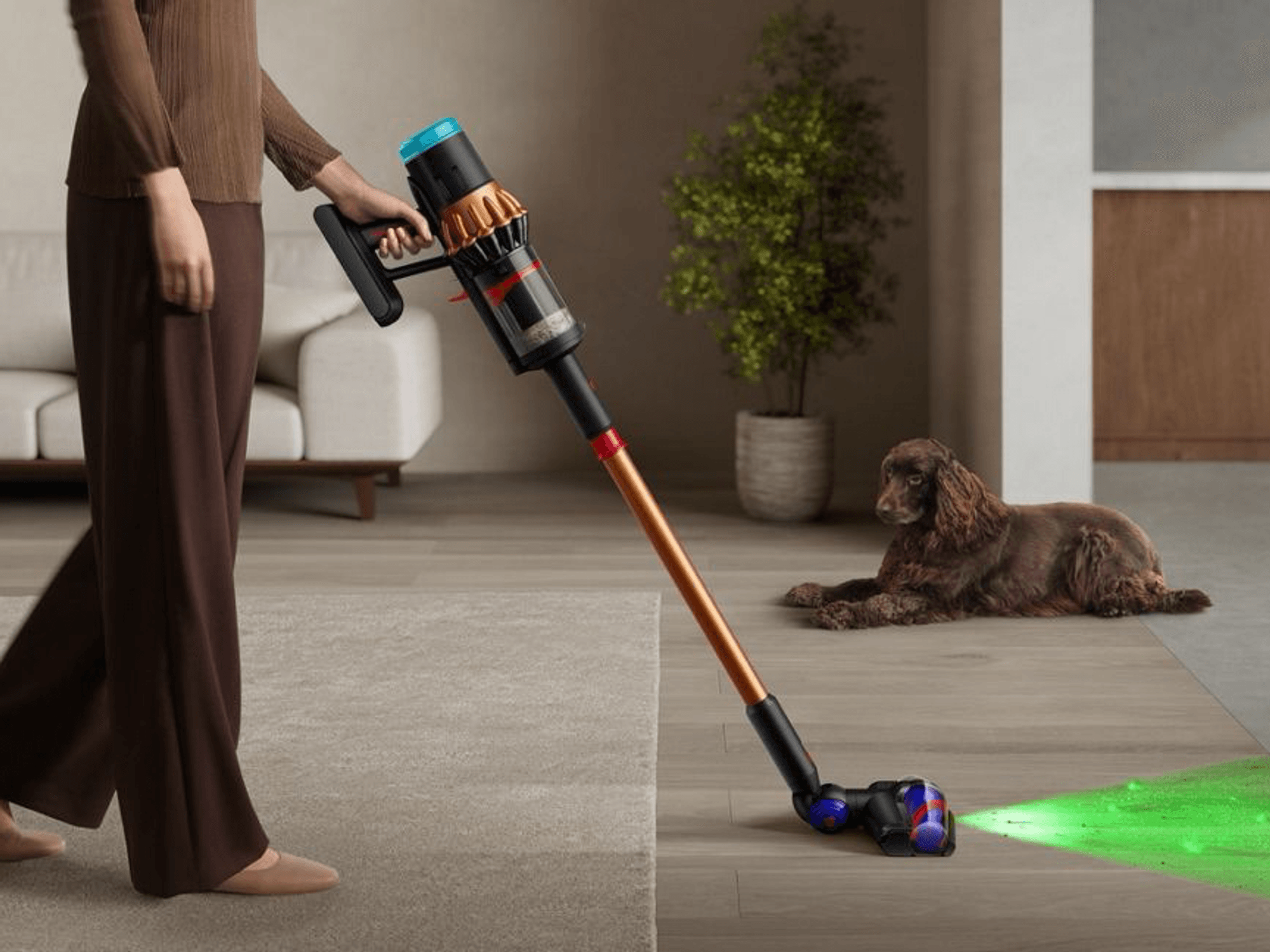 a woman walks from carpet to hard flooring with the V16 Piston Animal