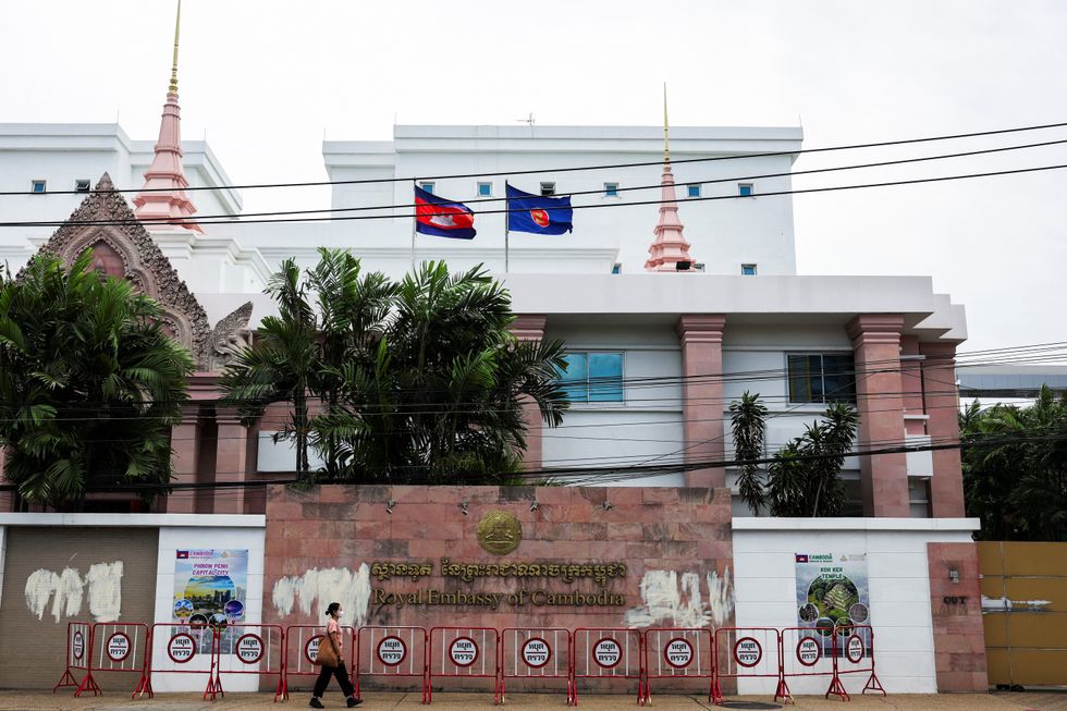 A woman walks past the embassy of Cambodia in Thailand after the latter recalled its ambassador