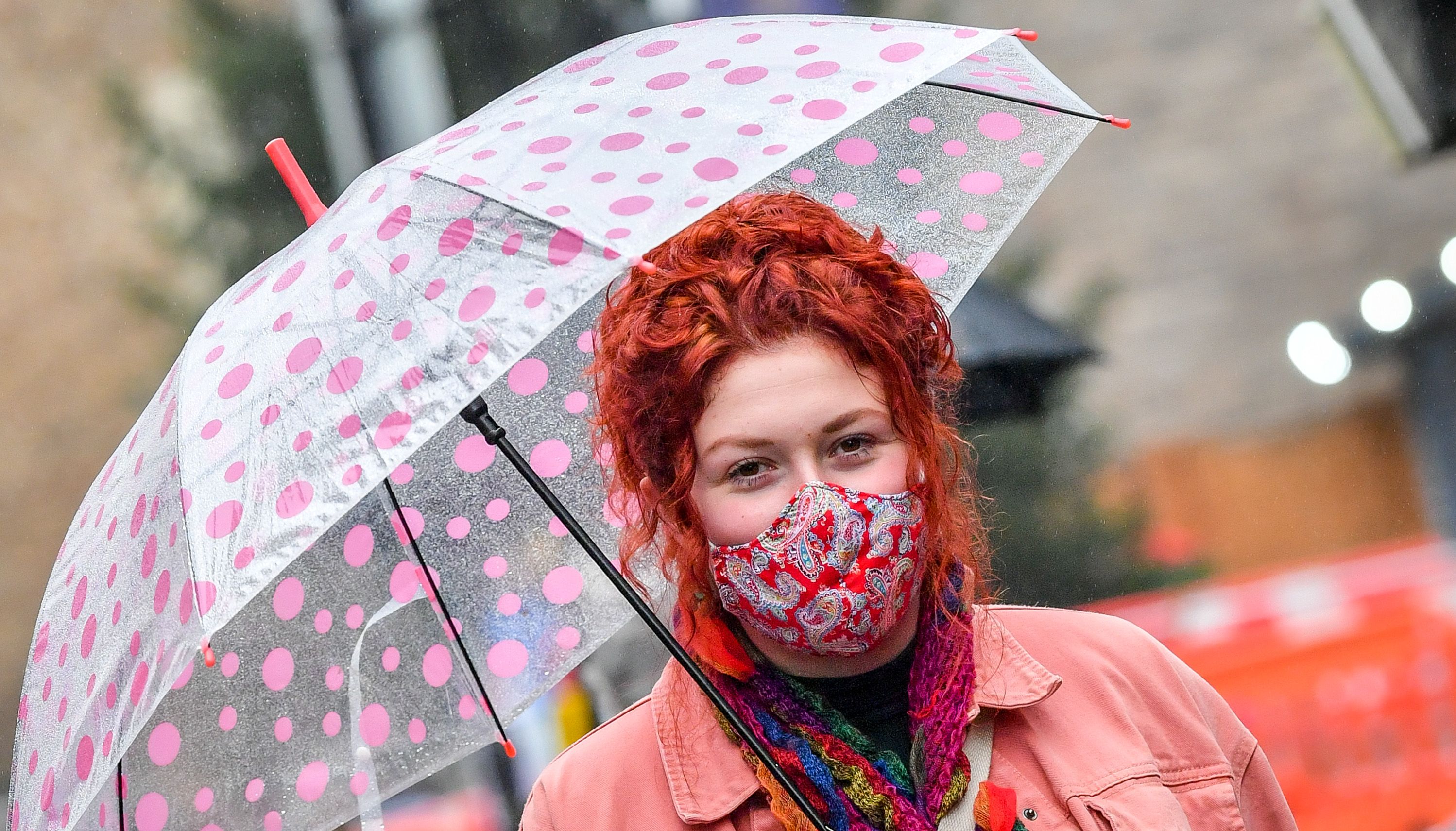 A woman wearing a face mask in the centre of Cardiff. Face coverings will remain mandatory on public transport in Wales and the requirement for them to continue to be worn in shops is being considered. Issue date: Sunday July 11, 2021.