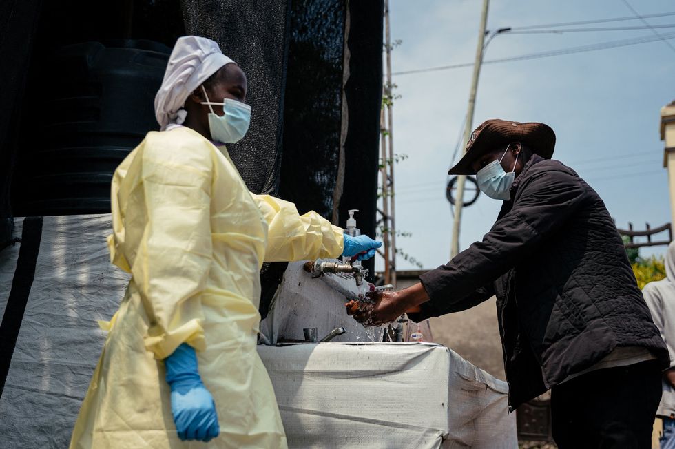 A woman wearing a mask and washes her hands in Kyeshero Hospital, in Goma, Democratic Republic of Congo