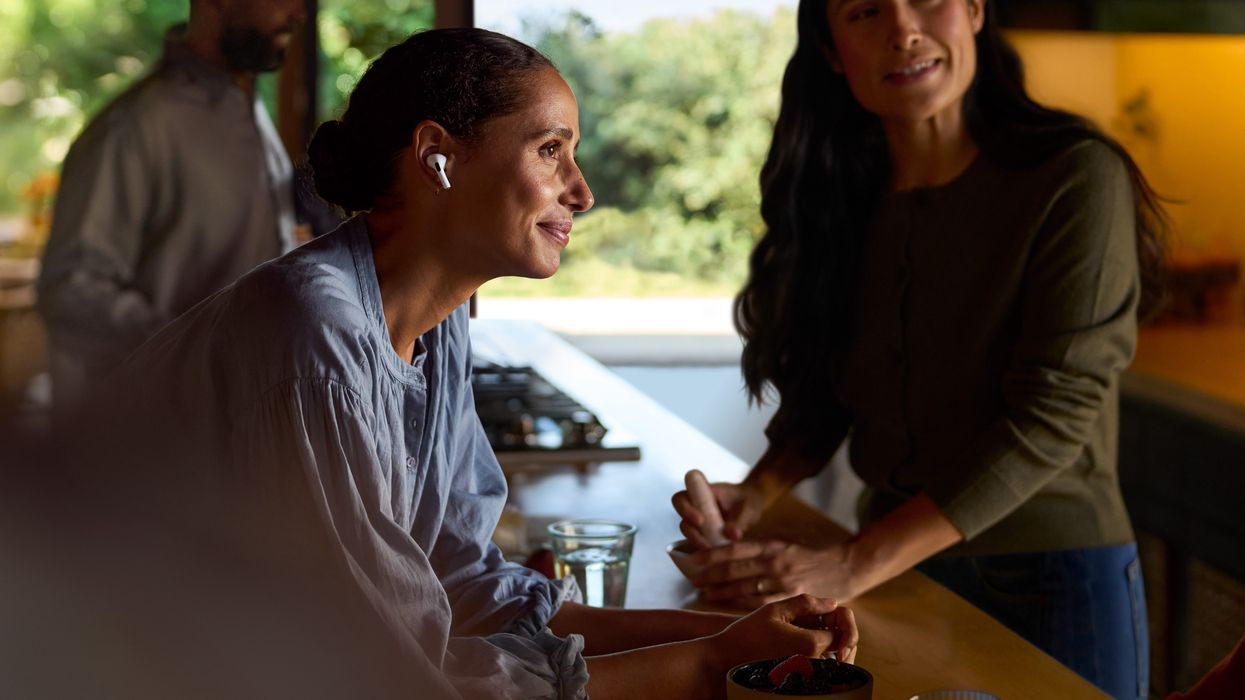 a woman wearing airpods pro 2 to listen to a conversation
