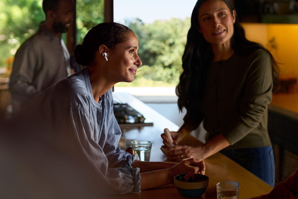 a woman wearing airpods pro 2 to listen to a conversation