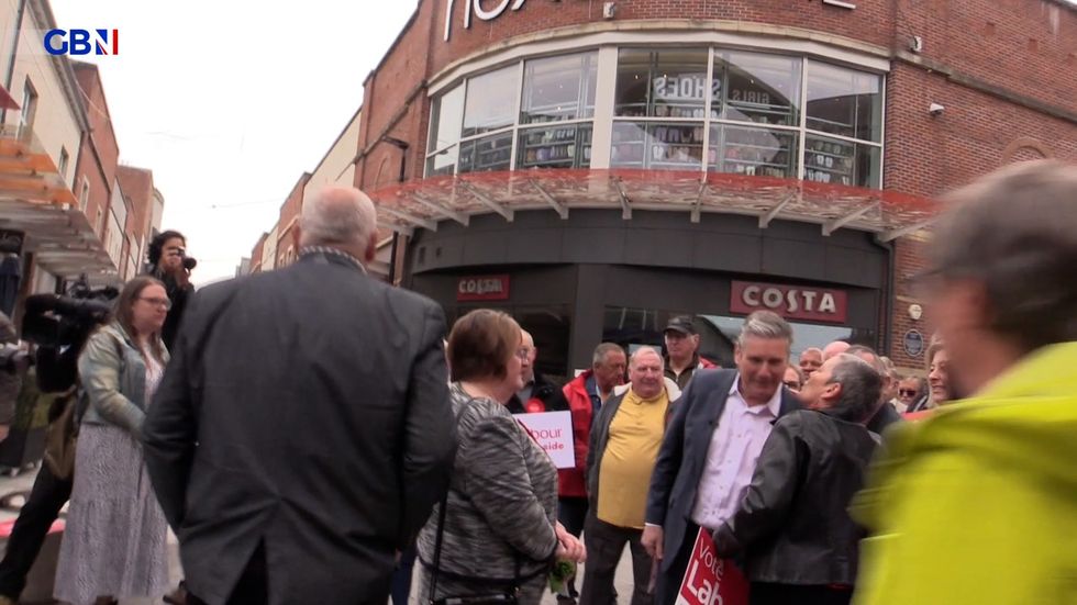 A women kissed Sir Keir Starmer on the cheek
