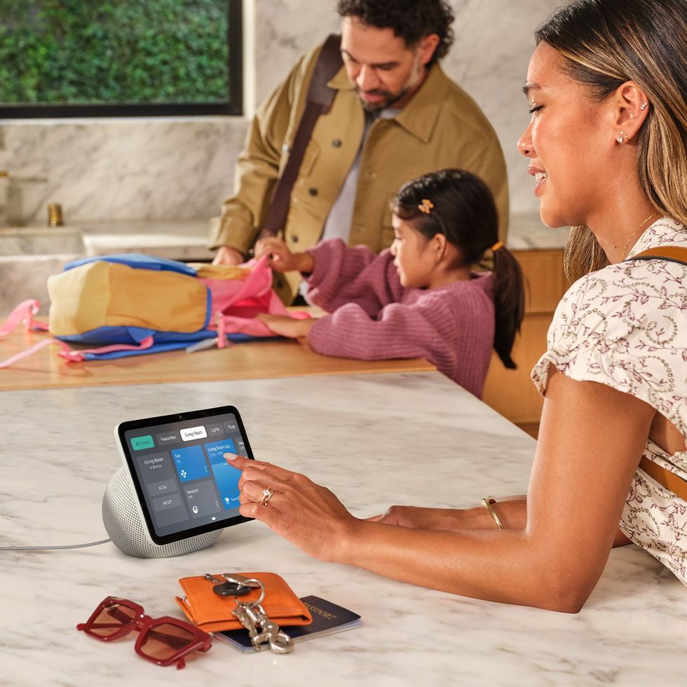 a women taps on a smart home control with the touchscreen control on an echo show 8