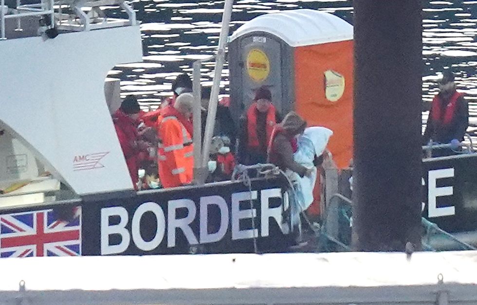A young child is carried from a Border Force vessel after arriving in Dover, Kent, following a small boat incident in the Channel. Picture date: Saturday November 12, 2022.