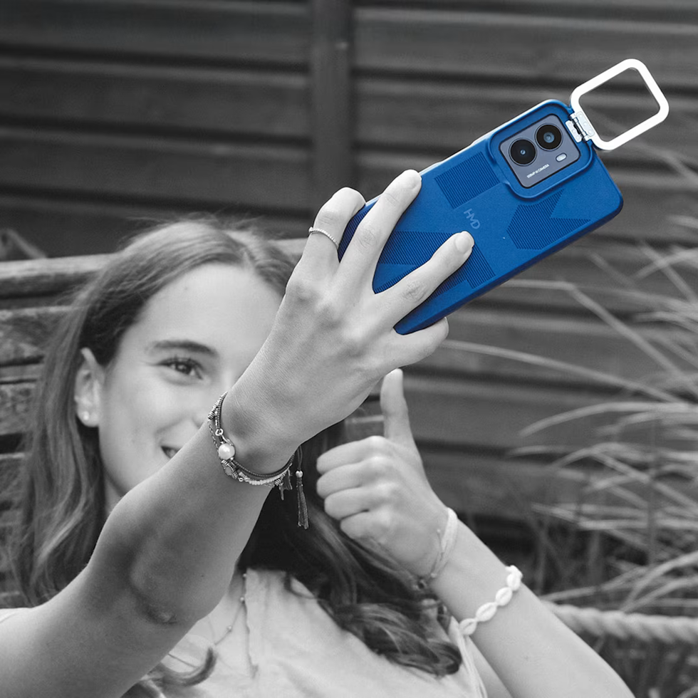 a young girl takes a selfie with the HMD Fuse phone
